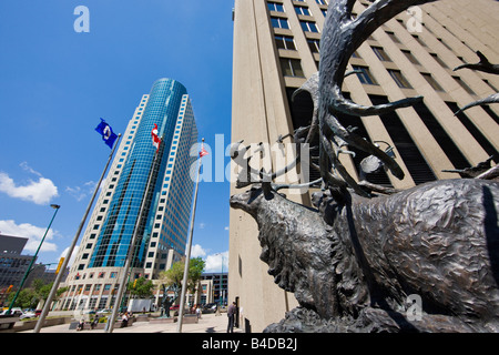 Bronze sculpture of caribous crossing river, outside the Richardson Building with the Canwest Place building