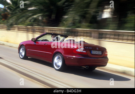 Car, Mercedes CLK 320, Convertible, model year 2003-, red, open top, driving, diagonal from the back, rear view, City Stock Photo