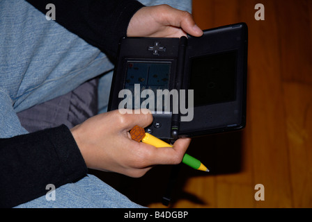 boy playing with Nintendo DS Lite Stock Photo