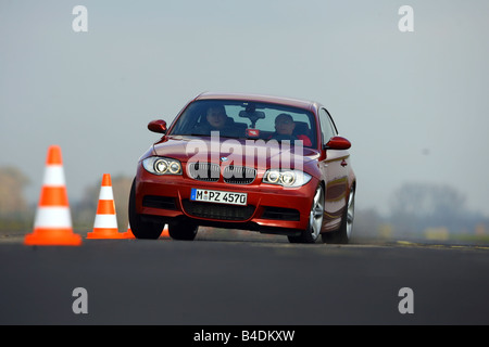 BMW 135i Coupe, driving, diagonal from the front, frontal view, Pilonen, test track, red, model year 2007- Stock Photo