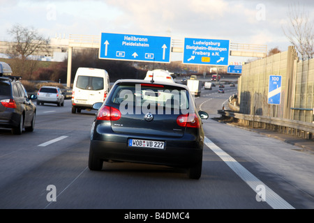 VW Volkswagen Golf Blue Motion, model year 2008-, dunkelblue moving, diagonal from the back, rear view, Highway A81 Stock Photo