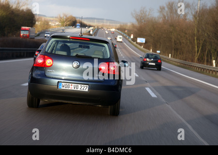 VW Volkswagen Golf Blue Motion, model year 2008-, dunkelblue moving, diagonal from the back, rear view, Highway A81 Stock Photo