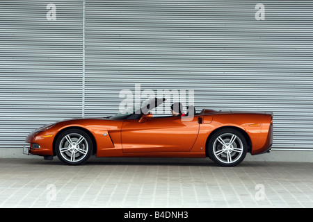 Corvette C6, rust-red model year 2008, orange -metallic, standing, upholding, side view, open top Stock Photo