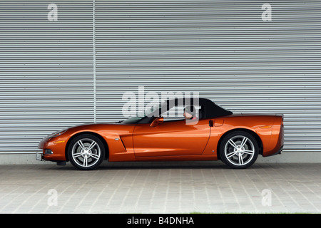 Corvette C6, rust-red model year 2008, orange -metallic, standing, upholding, side view, closed top Stock Photo