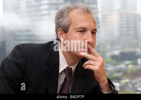 Businessman by the window in his office Stock Photo