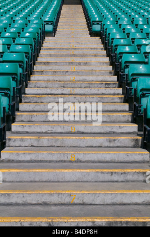 Numbered steps in a sports stadium in between the green pastic seating ...