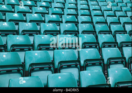 Rows of empty green plastic chairs in a sports stadium Stock Photo