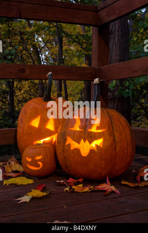 Halloween pumpkins head jack lantern with candles around on the old ...