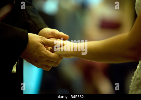 Bride and groom exchanging rings Stock Photo