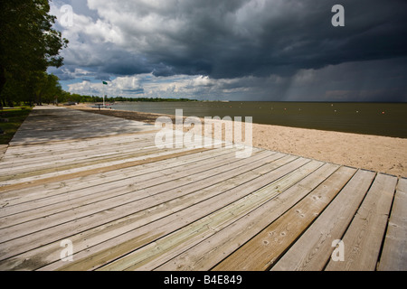 Threatening Clouds above the boardwalk on the shores of Lake Winnipeg in the town of Winnipeg Beach, Manitoba, Canada. Stock Photo