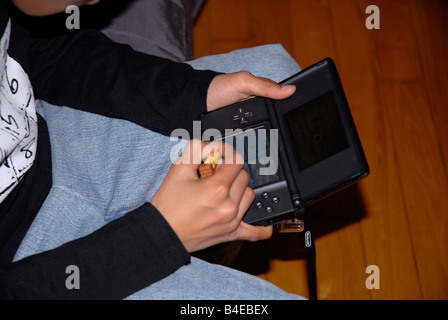 boy playing with Nintendo DS Lite Stock Photo