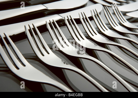 Silver Stainless Steel Cutlery Set on a Graduated Black Background With Reflection Including Knife Fork And Spoon Stock Photo