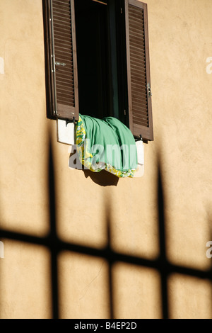 bedding left to air outside window in italy Stock Photo