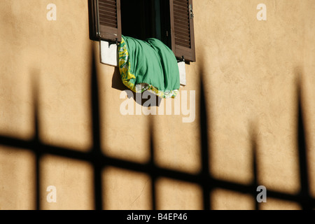 bedding left to air outside window in italy Stock Photo