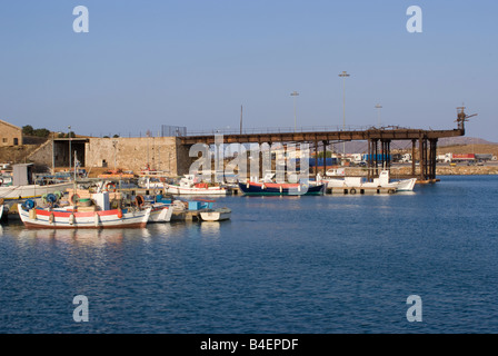 Part of the Inshore Greek Fishing Fleet in Lavrion Harbour with Old Manganese Ore Loading Conveyor Gantry Greek Mainland Greece Stock Photo