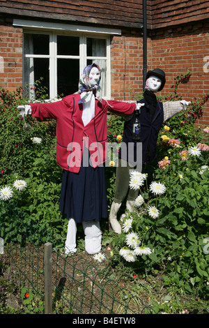 Drunken scarecrows in English front garden Stock Photo