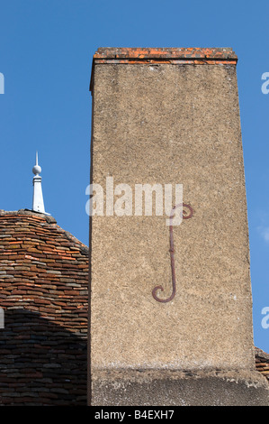 Decorative letter 'S' reinforcing chimney stack, Bélabre, France. Stock Photo