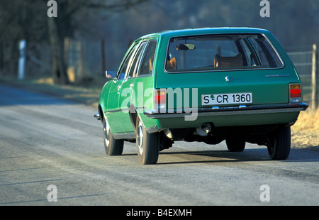 Car, Opel Rekord D 2000 Caravan, wagon, model year 1972-1977, old car,  green, driving, diagonal back, back view, road, country Stock Photo