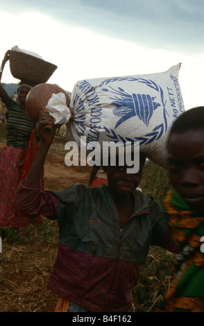 People carrying food supplies distributed by the WFP in Burundi. Stock Photo