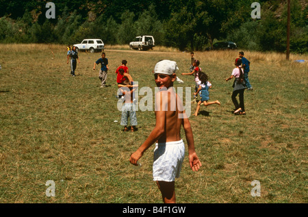Albanian and Serbian children playing together in field, Kosovo., Albania Stock Photo