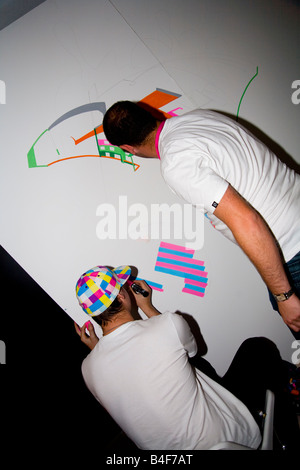 Graffiti artists draw and paint in a legal public show of their work. Stock Photo