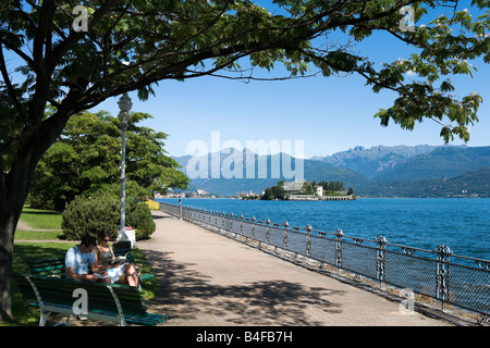 Promenade on the lakefront at Stresa looking towards Isola Bella (one of the Isole Borromee), Lake Maggiore, Italy Stock Photo