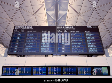 Flight announcement boards at Chek Lap Kok Airport in Hong Kong. Stock Photo