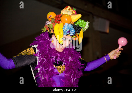 A joyful carnival entertainer helps the crowds have fun at a street carnival. Stock Photo