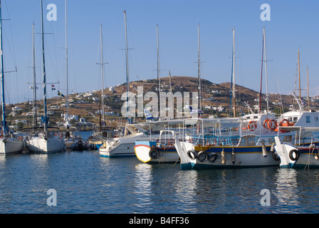 Fishing Boats and Luxury Yachts Moored in Paros Town Harbour Isle of Paros Cyclades Islands Aegean Sea Greece Stock Photo