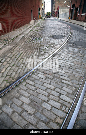 Old trolley tracks on a cobblestone street in Dumbo, Brooklyn, NY, USA Stock Photo