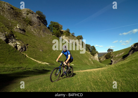 Mountain biking through Cavedale Castleton Peak District National Park Derbyshire England UK GB