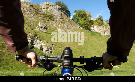 Mountain biking through Cavedale Castleton Peak District National Park Derbyshire England UK GB Stock Photo