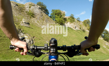 Mountain biking through Cavedale Castleton Peak District National Park Derbyshire England UK GB Stock Photo