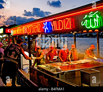Restaurant terrace boats Golden Horn bridge waterfront selling hot mackerel fish sandwiches balik ekmek Eminonu Stock Photo