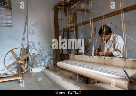 A man weaving at one of the cooperatives in an area that is famous for its saris,Birbhum, West Bengal state, India, Asia Stock Photo
