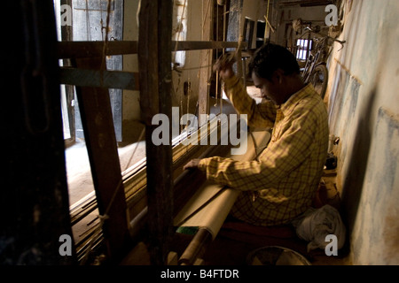 A man weaving at one of the cooperatives in an area that is famous for its saris,Birbhum, West Bengal state, India, Asia Stock Photo