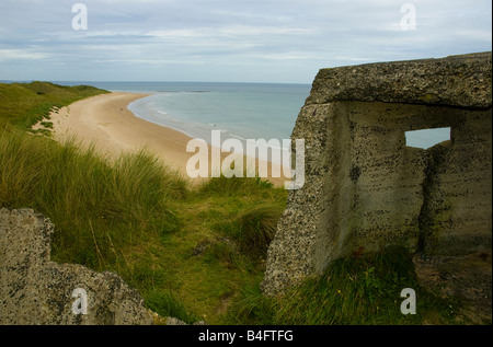 An abandoned 'pill box' sits atop of high sand dunes near Seahouses on the Northumberland coast of England Stock Photo