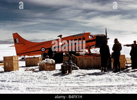 The Trans Antarctic Expedition 1956 1958 the group s plane sitting on the snow as supplies are unloaded 20th January 1956 Explorers meet at South Pole Members of the team attempting the first surface crossing of the Antarctic have joined up at the South Pole New Zealander Sir Edmund Hillary who has already conquered Mount Everest arrived with his team 17 days ago Early this afternoon Sir Edmund welcomed the British team led by Dr Vivian Bunny Fuchs to the South Pole The British and New Zealand teams are members of a joint Commonwealth Trans Antarctic expedition but set off from opposite ends Stock Photo
