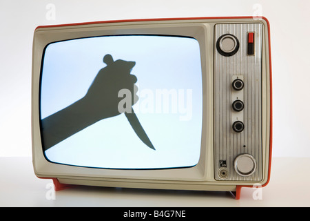 A television with a black and white image of a human hand holding a knife, silhouette Stock Photo