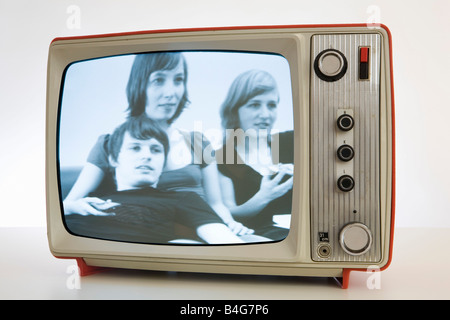 A television with a black and white image of three young people Stock Photo