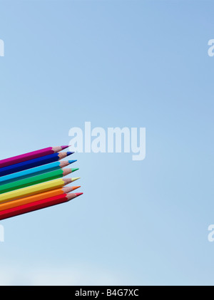 A rainbow of colored pencils against a blue sky Stock Photo