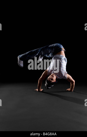 A B-boy doing a Handstand Freeze breakdance move Stock Photo