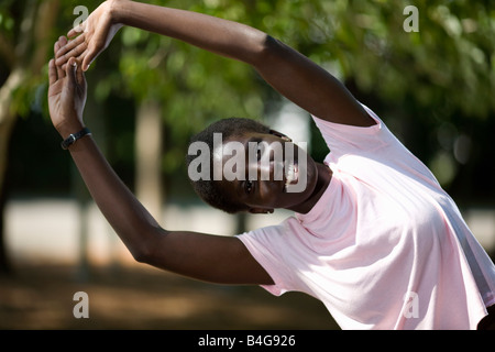 A young woman doing a side stretch Stock Photo