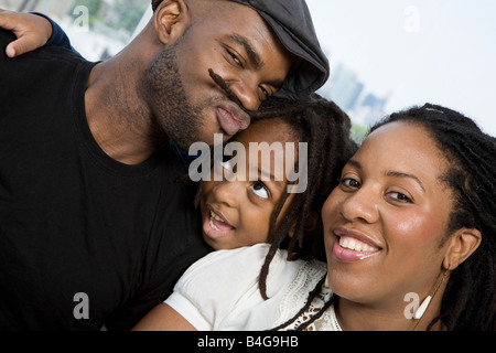 Two parents and their son goofing around Stock Photo