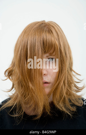 A woman with tousled hair hanging in her face Stock Photo