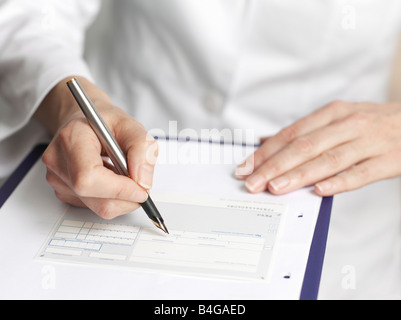Human hands filling out medical paperwork Stock Photo