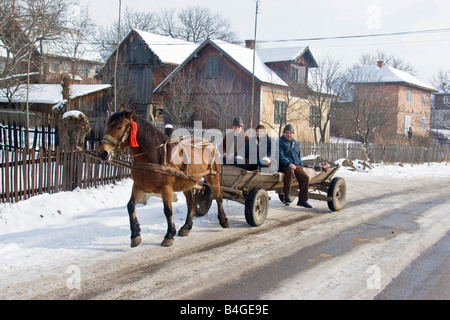 A group of adults traveling on horse cart in rural Romania, Cacica. Stock Photo