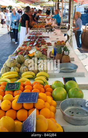 Shoppers buy fruit from a market stall in Cours Saleya in the old town in Nice France Stock Photo