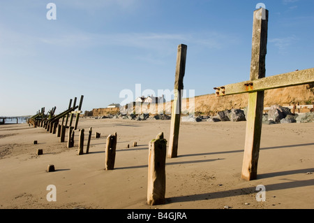 Eroding coast and failed sea defences with houses on edge of cliffs Happisburgh Norfolk Stock Photo
