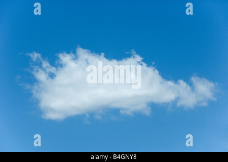 A single white cumulus cloud in a blue sky. Stock Photo